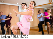 Girl and guy enjoying lindy hop in dance studio. Стоковое фото, фотограф Яков Филимонов / Фотобанк Лори