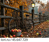 A bicycle is leaning against a wooden fence, with a bucket of fresh apples collected next to it. Apple Savior (August 19). Стоковое AI-изображение, AI-художник Сергей Елизарьев / Фотобанк Лори