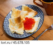 On plate - ruddy soft pancakes with spoonful fresh-grain caviar. Стоковое фото, фотограф Яков Филимонов / Фотобанк Лори