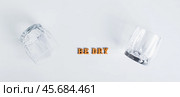 Dry January concept, empty glasses and text on grey background top view web banner. Стоковое фото, фотограф Елена Руй / Фотобанк Лори