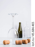 Alcohol abstinence, upside down wine glass among corks on table vertical view. Стоковое фото, фотограф Елена Руй / Фотобанк Лори