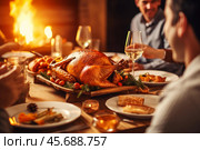 Family celebrating thanksgiving with roasted turkey on festive table near fireplace. Стоковое AI-изображение, AI-художник Иван Рябоконь / Фотобанк Лори