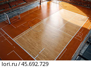 Professional volleyball courts with white lines, nobody. Crop photo of orange volleyball court in sport gym, sporty backdrop. Team game success, healthy sporty lifestyle concept. Copy ad text space. Стоковое AI-изображение, AI-художник Aleksandr Golubev / Фотобанк Лори