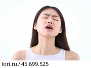 Young woman feeling strong emotions of disgust and anger on white background. Стоковое AI-изображение, AI-художник Иван Рябоконь / Фотобанк Лори