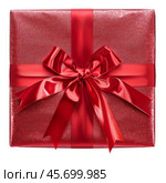 Shiny red gift box with a big ribbon and bow on white background. Стоковое AI-изображение, AI-художник Иван Рябоконь / Фотобанк Лори