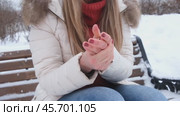 A young woman warms her hands in the cold by rubbing. Snow, winter, cold. Стоковое видео, видеограф Терехова Марина / Фотобанк Лори