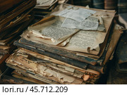 Stack of old papers and books covered in dust. Стоковое AI-изображение, AI-художник Иван Рябоконь / Фотобанк Лори