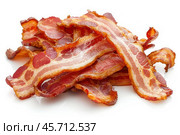 Delicious crispy bacon rashers piled up on white background. Стоковое AI-изображение, AI-художник Иван Рябоконь / Фотобанк Лори