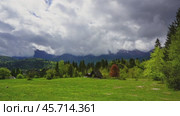 Mountain alps with house and trees in fog clouds. Стоковое видео, видеограф Михаил Коханчиков / Фотобанк Лори