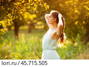 Young woman in dress in summer garden. Стоковое фото, фотограф Дмитрий Киселёв / Фотобанк Лори