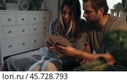 Mature Couple, Wife with Husband looks with interest at a vintage photography. Man and Woman looking at family photos. Genealogy, the memory of ancestors, family ties, memories of childhood. History. Стоковое видео, видеограф Марина Демидюк / Фотобанк Лори