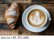 Cup of frothy cappuccino coffee with croissants on rustic wood background. Hot coffee latte with art milk foam and freshly-baked Brioche on table in cafe. Breakfast or coffee break. Morning ritual. Стоковое AI-изображение, AI-художник Марина Демидюк / Фотобанк Лори