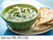 Traditional Greek Tzatziki dip sauce made with cucumber sour cream. Yogurt sauce with dill, lemon juice, olive oil. Served with toasted Za'atar Pita bread. Top view. Tarator, cacik or tartar. Стоковое AI-изображение, AI-художник Марина Демидюк / Фотобанк Лори
