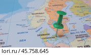 Denmark - Travel concept with green pushpin on the world map. The location point on the map points to Copenhagen the capital of the Denmark. Стоковое видео, видеограф Андрей Армягов / Фотобанк Лори