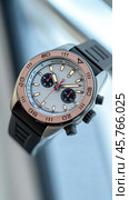 Luxury chronograph watch with rose gold bezel and black rubber strap. Стоковое AI-изображение, AI-художник Юрий Поздников / Фотобанк Лори