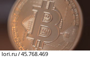 Gold Bitcoin Symbol beautifully placed on a Wooden Surface. Close up. Стоковое видео, видеограф Степанов Григорий / Фотобанк Лори
