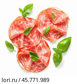 Italian coppa ham slices decorated with fresh basil leaves on white background. Стоковое AI-изображение, AI-художник Иван Рябоконь / Фотобанк Лори