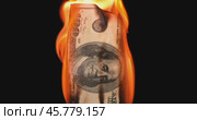 USA dollar bill money is burning in the fire, the concept of the economic crisis of inflation and currency devaluation. Стоковое видео, видеограф Андрей Армягов / Фотобанк Лори