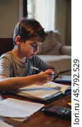 Child deeply focused on completing homework assignments. Стоковое видео, видеограф Данил Руденко / Фотобанк Лори