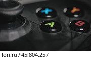 Modern gamepad on a dark. Game controller close-up. Стоковое видео, видеограф Андрей Армягов / Фотобанк Лори