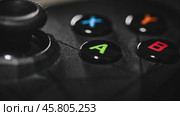 Modern gamepad on a dark. Game controller close-up. Стоковое видео, видеограф Андрей Армягов / Фотобанк Лори