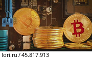 Gold Bit Coin BTC coins on the motherboard. Bitcoin is a worldwide cryptocurrency and digital payment system called the first decentralized digital currency. Стоковое видео, видеограф Андрей Армягов / Фотобанк Лори