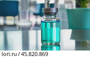 Medical vial for injection on blurred background. Vaccine vial with blue liquid. Health care concept. Transparent glass vial mock up with clear liquid on a shadowed surface. Healthcare innovations. Стоковое AI-видео, аниматор Марина Демидюк / Фотобанк Лори