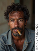 A young man residing in Cuba smokes a cigar while looking directly at the viewer, showcasing a unique hairstyle and a calm demeanor in a vibrant environment. Generative AI. Стоковое AI-изображение, AI-художник Юлия Петровская / Фотобанк Лори