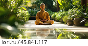 Young buddhist monk meditating in a peaceful garden with reflection. Стоковое AI-изображение, AI-художник Юрий Поздников / Фотобанк Лори