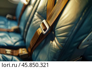 Empty airplane seats with seatbelts fastened and ready for passengers. Стоковое AI-изображение, AI-художник Иван Рябоконь / Фотобанк Лори
