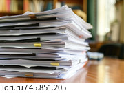 Stack of documents piling up on a desk in an office. Стоковое AI-изображение, AI-художник Иван Рябоконь / Фотобанк Лори