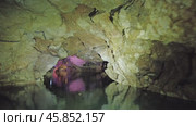 Boating on underground river in dark cave. Стоковое видео, видеограф Михаил Коханчиков / Фотобанк Лори