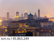Illuminated Bergamo upper city in misty winter twilights, Italy. Стоковое фото, фотограф Яков Филимонов / Фотобанк Лори