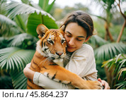 Image portrait of pretty young woman hugging wild tiger. Relationship between man and animals. Wild animals in a natural wildlife habitat. Animal protection, volunteering, nurseries, zoos. Стоковое AI-изображение, AI-художник Анна Сивакова / Фотобанк Лори