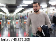 Male passenger in casual clothing near baffle gate in underground platform closeup. Стоковое фото, фотограф Яков Филимонов / Фотобанк Лори
