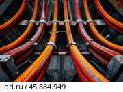 Electrical conduits powering infrastructure, complex network of cables supporting modern technology. Стоковое AI-изображение, AI-художник Иван Рябоконь / Фотобанк Лори
