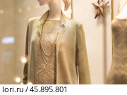 An elegant showcase of an expensive luxury store with stylish mannequins in clothes and evening lighting. The concept of shopping and sales. Стоковое фото, фотограф Photojuli / Фотобанк Лори