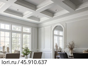 Coffered ceiling enhancing elegant dining room with wainscoting. Стоковое AI-изображение, AI-художник Иван Рябоконь / Фотобанк Лори