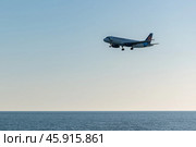 Самолет над морем заходит на посадку. Закатное небо. Редакционное фото, фотограф Anton Leonchikov / Фотобанк Лори