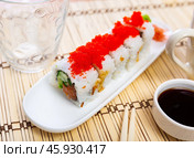 Uramaki Tobiko roll with salmon, cucumber, avocado wrapped in rice with tobiko caviar. Стоковое фото, фотограф Яков Филимонов / Фотобанк Лори