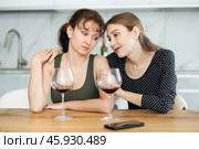 Sad woman sits silently in kitchen, friend sympathize and comfort her. Стоковое фото, фотограф Яков Филимонов / Фотобанк Лори