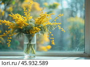 A beautiful fluffy bouquet of mimosa in a vase. Close-up. The concept of spring at home and International Women's Day on March 8th. Стоковое AI-изображение, AI-художник Photojuli / Фотобанк Лори
