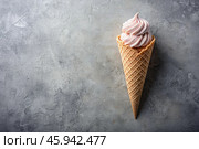 Sweet dessert. Ice cream cones with different flavors on a concrete gray background. World Ice Cream Day. Стоковое AI-изображение, AI-художник Photojuli / Фотобанк Лори