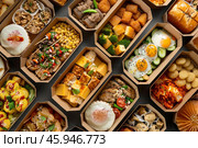 Catered food boxes filled with various dishes for office lunch or event. Стоковое AI-изображение, AI-художник Иван Рябоконь / Фотобанк Лори