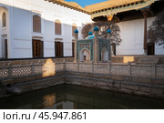 View of the courtyard of the Bahauddin Naqshbandi Memorial Complex with a pond and a chartak in the foreground on a sunny day, Bukhara, Uzbekistan. Стоковое фото, фотограф Ula Ulachka / Фотобанк Лори