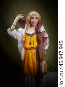 Rebekah from the Christian Bible poses in eastern national clothing, holding a pot, showcasing cultural heritage during a studio shoot. Стоковое фото, фотограф Кривошеина Елена Леонидовна / Фотобанк Лори