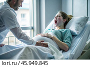A pregnant woman in a hospital bed in the maternity ward. The woman is in labor and screaming in pain. Pregnancy and childbirth. Стоковое AI-изображение, AI-художник Photojuli / Фотобанк Лори