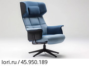 Modern blue office swivel chair standing on white background. Стоковое AI-изображение, AI-художник Иван Рябоконь / Фотобанк Лори