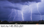 Lightning thunderstorm. Lightning strikes on a dark sky. Flashes of lightening storm over modern city residential area. Bolts striking in the horizon. Stormy Night. Thunderstorm. Thunderbolt, thunder. Стоковое AI-видео, аниматор Марина Демидюк / Фотобанк Лори
