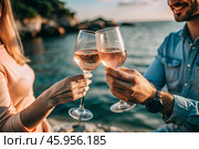 Glasses of pink sparkling wine in the hands of a couple in love. People on a romantic date. The concept of love. Стоковое AI-изображение, AI-художник Photojuli / Фотобанк Лори
